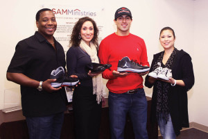 (Pictured L-R): Navarra R. Williams, president and CEO of SAMMinistries, Jessica Renee, co-founder of A Walk in My Shoes, Eric Castillo, UIW student and co-founder of A Walk in My Shoes, and Vanessa Rodriguez, volunteer to A Walk in My Shoes, display onated shoes at the administrative offices of SAMMinistries.